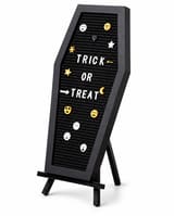 Black coffin-shaped Halloween letter board on its stand with Trick or Treat lettering and emoji pieces