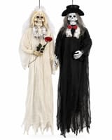 Skeleton bride and groom hanging Halloween decorations in wedding costumes