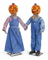 Two animated pumpkin twins: one in a blue pinafore dress and one in blue overalls