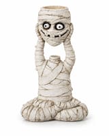 Seated bandaged mummy holding its grinning head overhead, with an empty tealight recess in the top