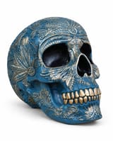 Blue decorative skull with raised botanical patterns highlighted in gold and gold teeth, shown at a three-quarter angle