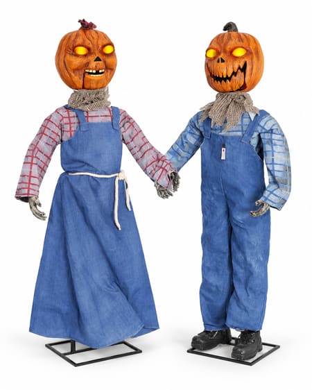 Two animated pumpkin twins: one in a blue pinafore dress and one in blue overalls
