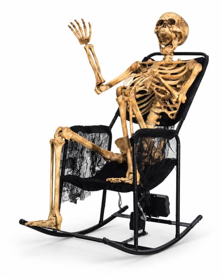 Weathered skeleton waving from a black metal rocking chair with dark gauze and animation mechanism