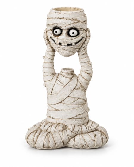 Seated bandaged mummy holding its grinning head overhead, with an empty tealight recess in the top