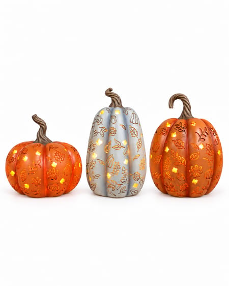 Orange Short, Grey Tall and Orange Tall light up pumpkins with glowing autumn cut-outs