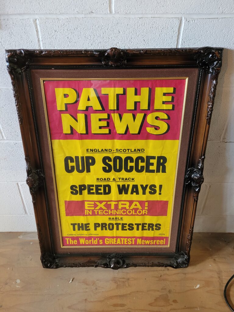 Framed Pathe News Poster