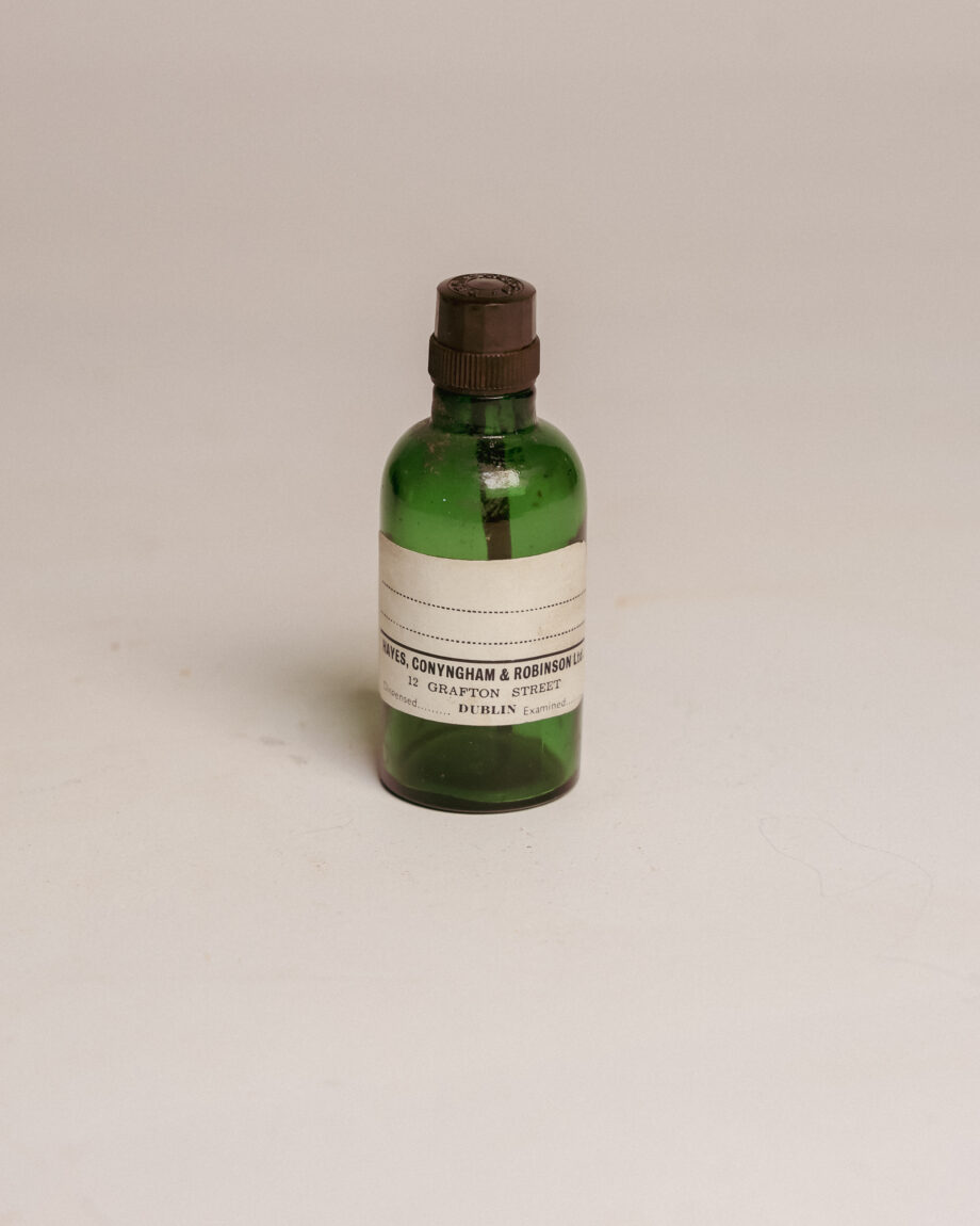 A small green bottle with a label.