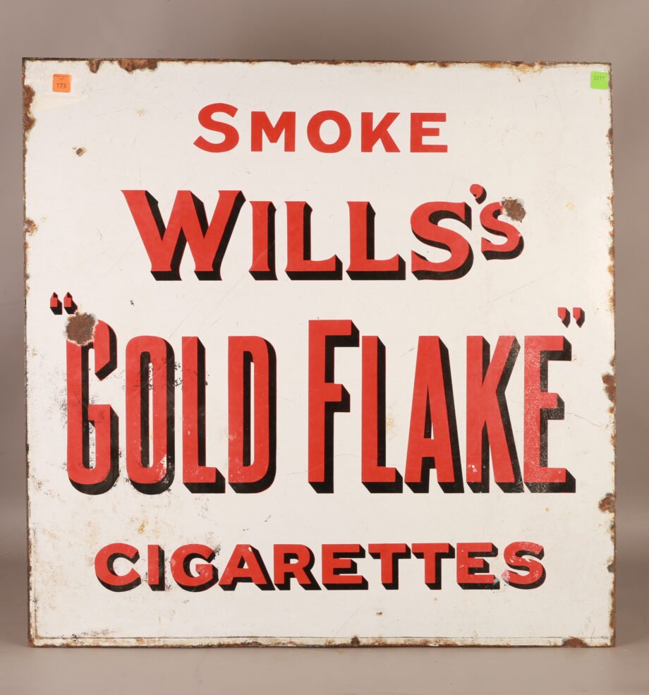 A sign that says "Smoke Will's Gold Flake Cigarettes"