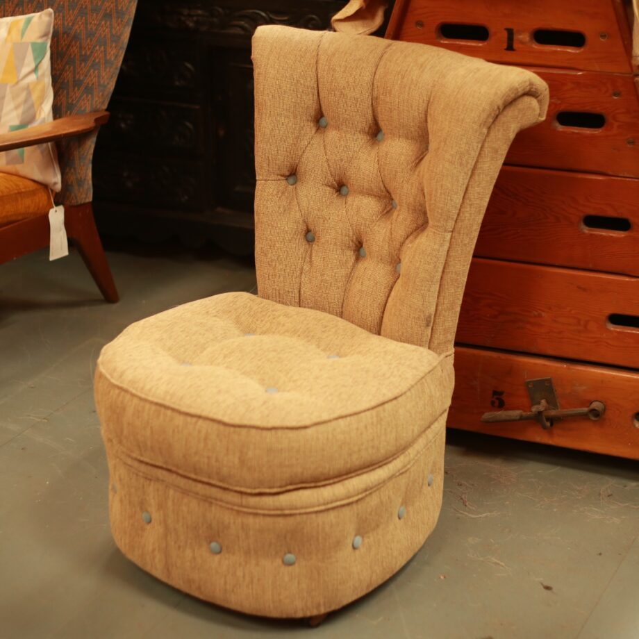 A reupholstered Victorian nursing chair in a beige fabric. 