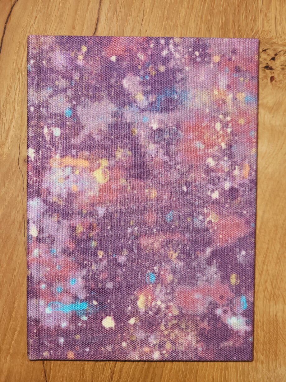 A notebook with a purple spatter cover