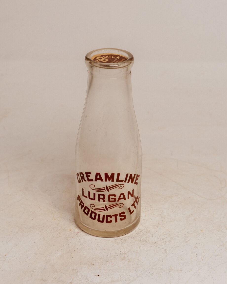 A small milk bottle that says "Creamline Lurgan Products LTD" in a red font.
