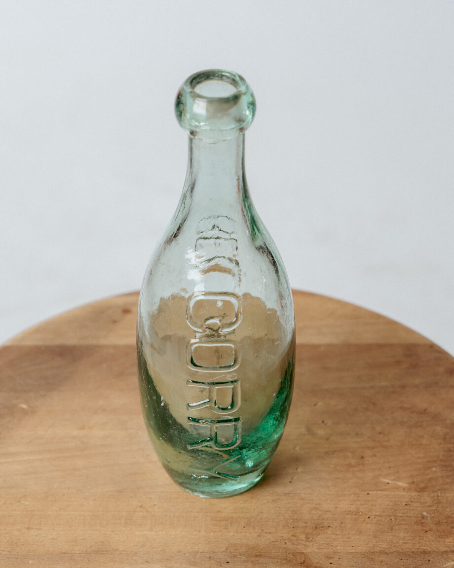 A light green bottle with vertical writing.