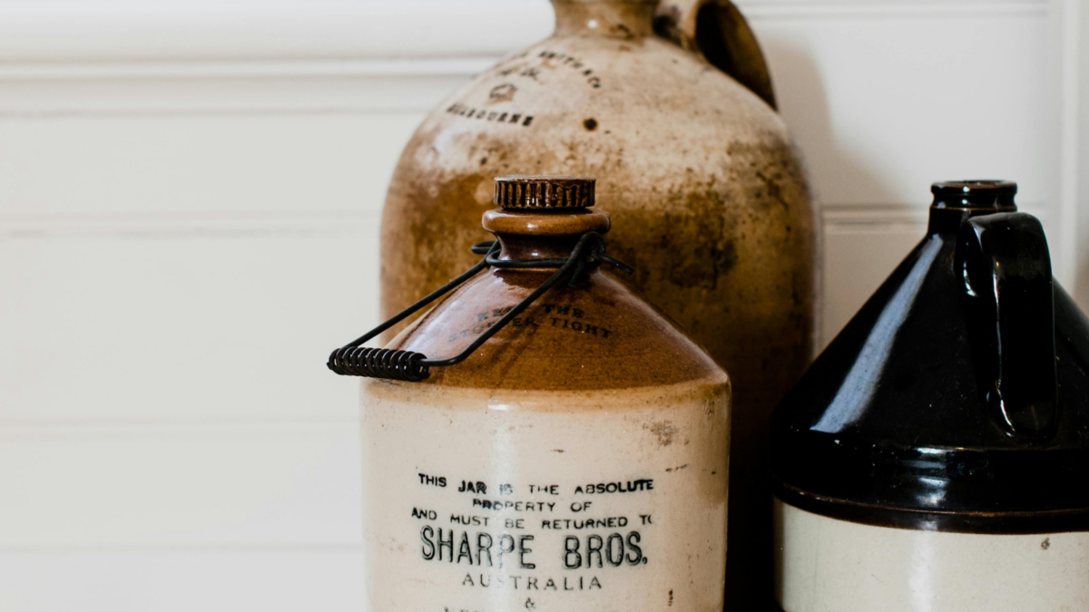 A picture of three large stoneware bottles.