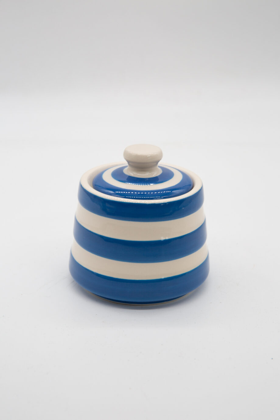 A blue and white striped sugar bowl