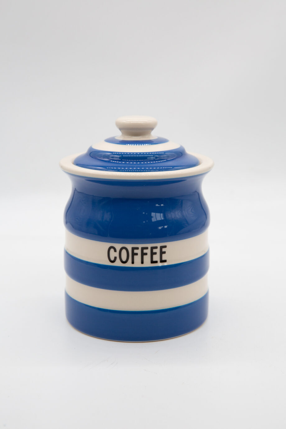 A blue and white striped jar that says coffee on it