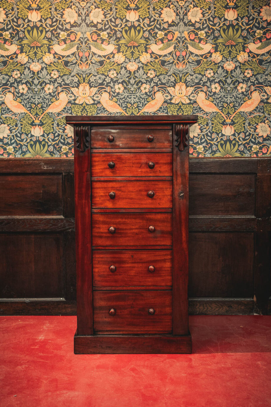 A short mahogany set of drawers.