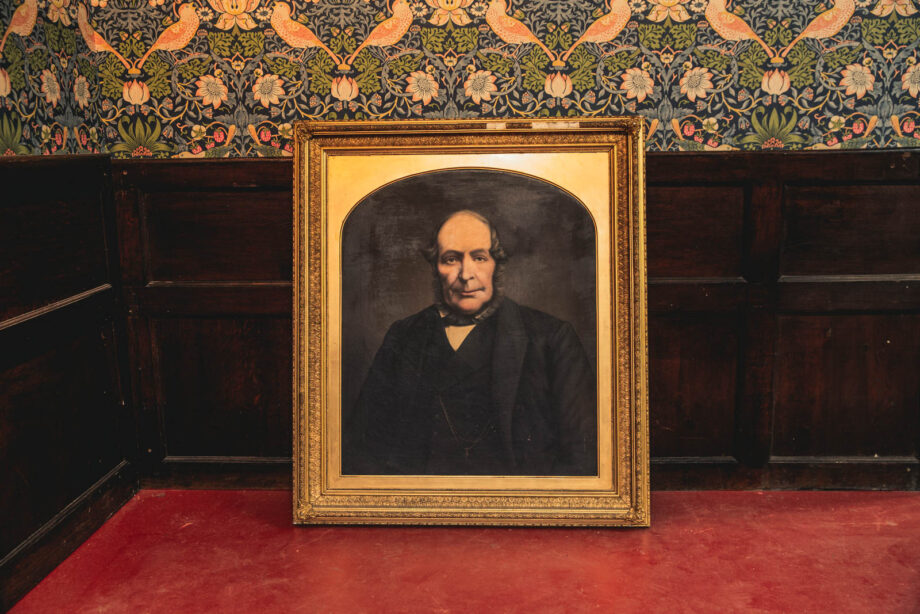 A painting of a man in a gold frame