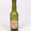 Vintage Guinness Extra Stout bottle with original label and embossed details, made of green glass.