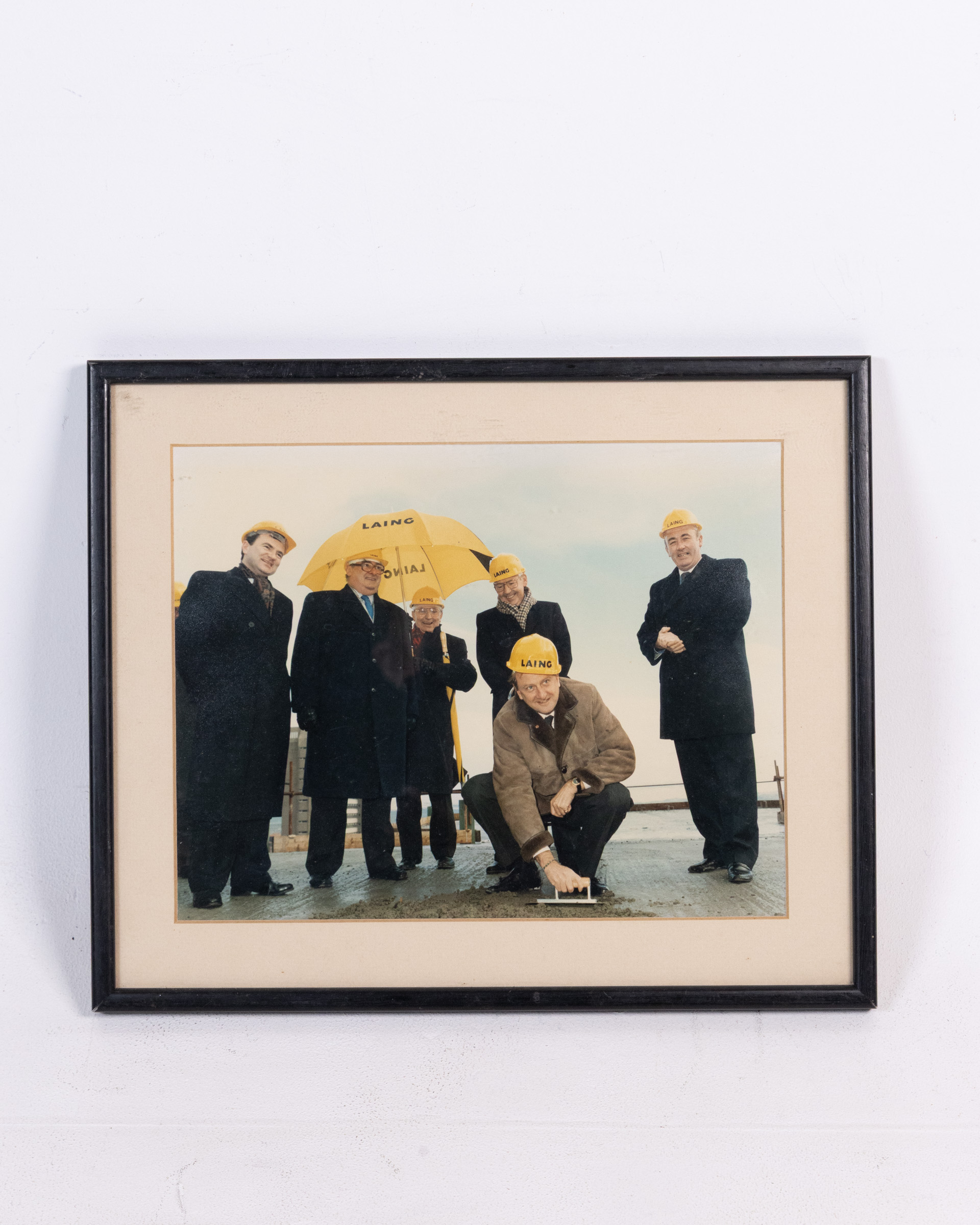 Framed Photographic Print of Laing Construction Workers with Umbrellas