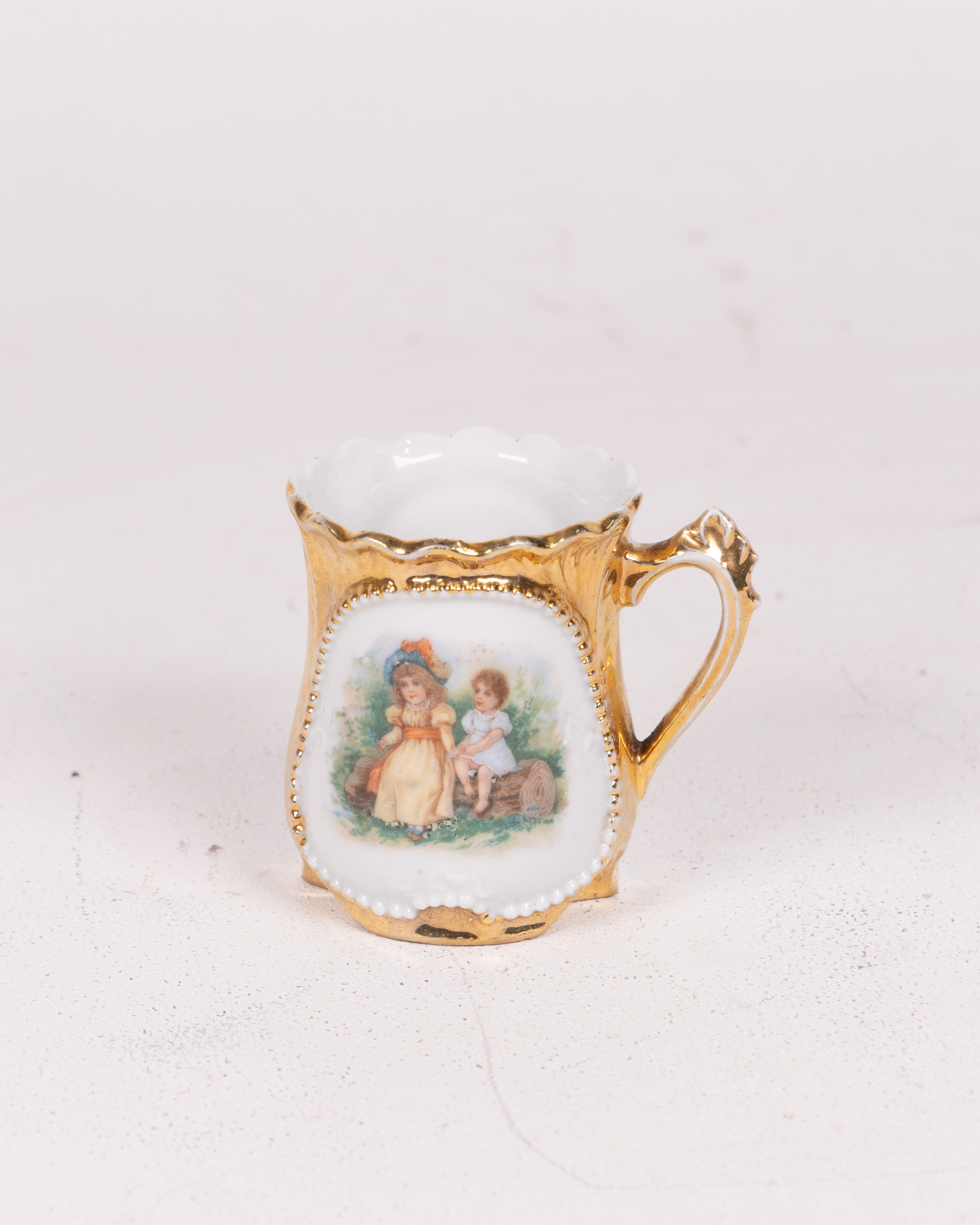 Vintage Ornamental Cup with Gold Accents and Figural Illustration