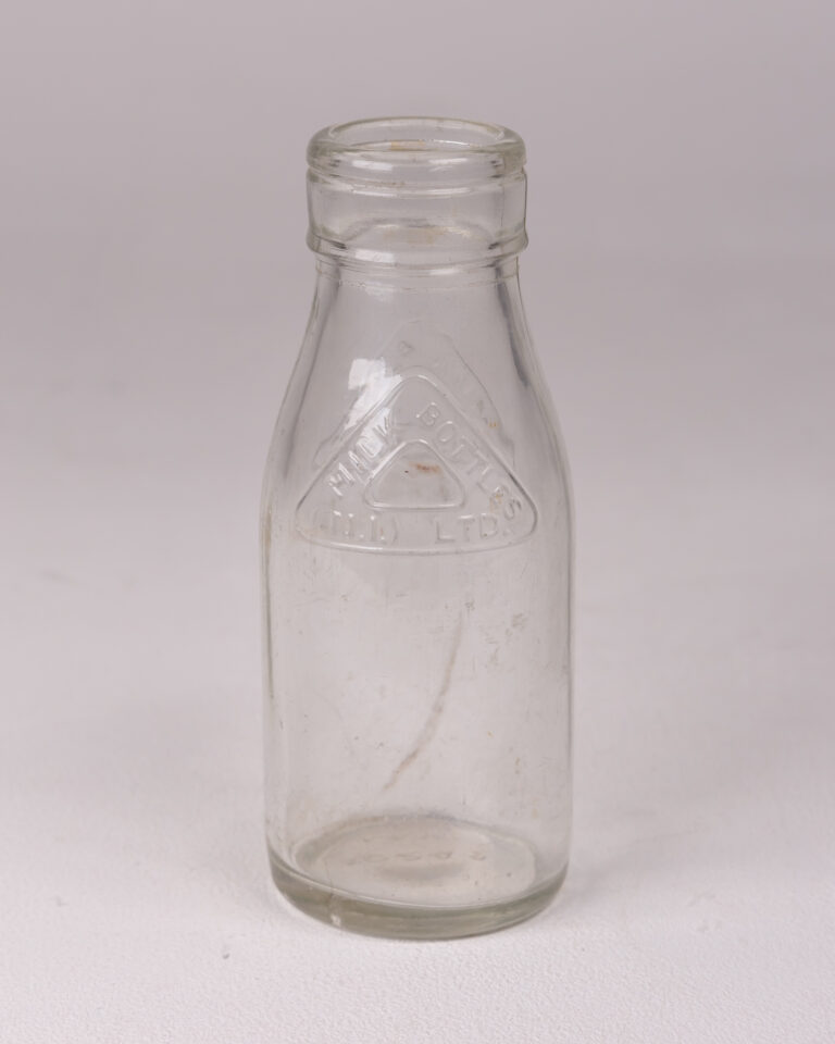 Vintage Clear Glass Milk Bottle with 'MILK BOTTLES (N.I.) LTD' Embossed Logo