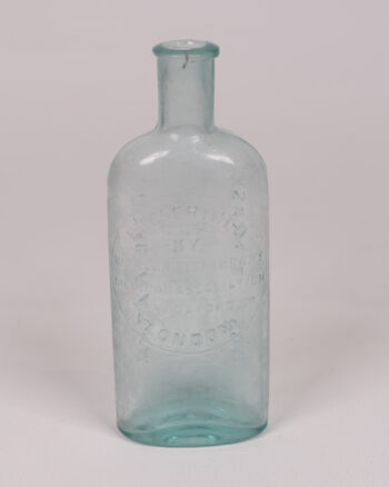 Vintage Turquoise ‘Worlds Dispensary’ Embossed Glass Medicine Bottle
