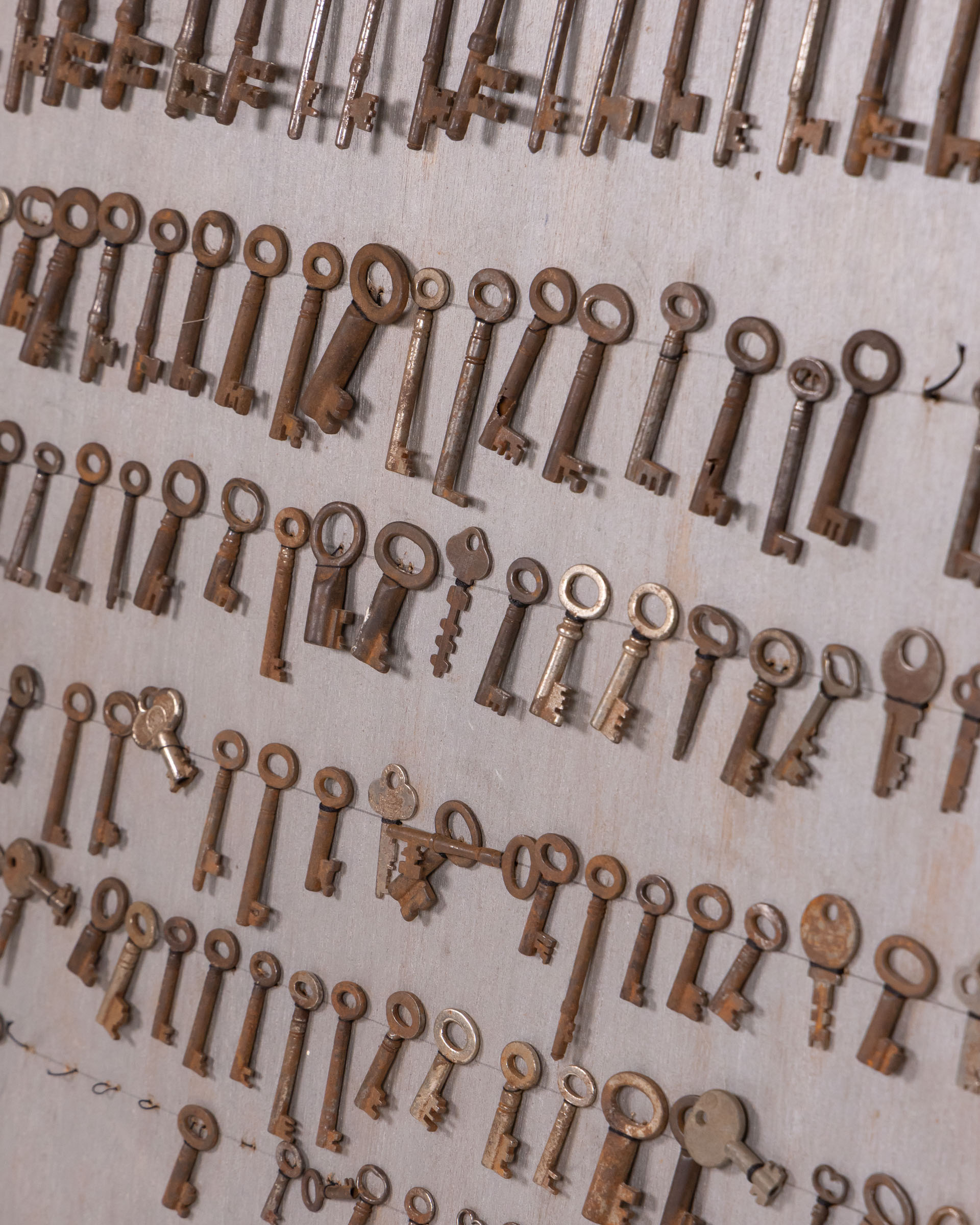 Rustic Vintage Key Collection Mounted on Wooden Display Board