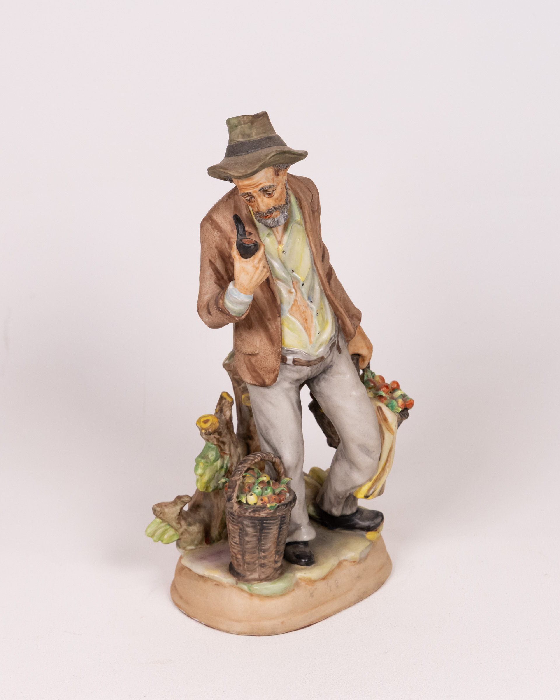 Vintage Porcelain Figurine of a Man with Fruit Basket and Pipe, Ornament