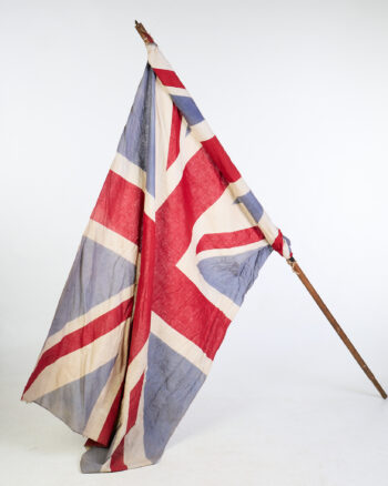 Vintage Union Jack Flag on Wooden Pole with Wear