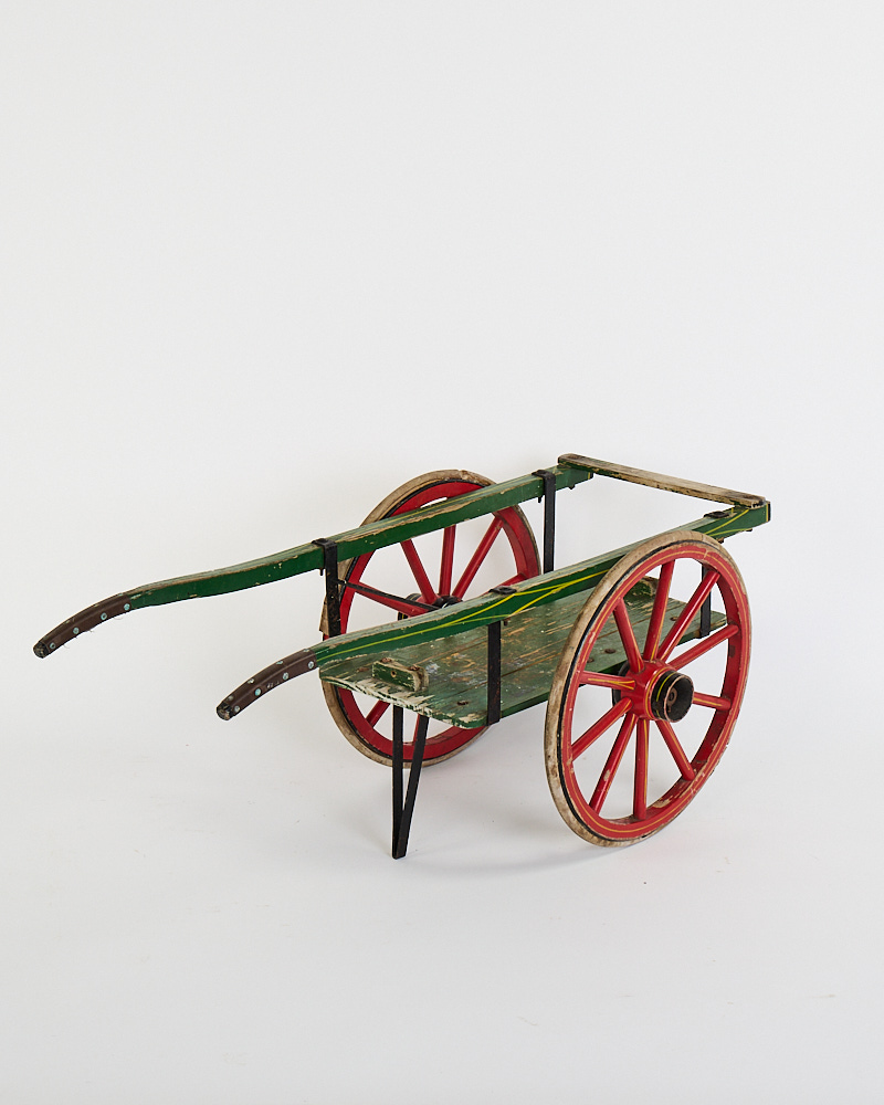 Vintage Wooden Cart with Red Spoked Wheels and Green Paint