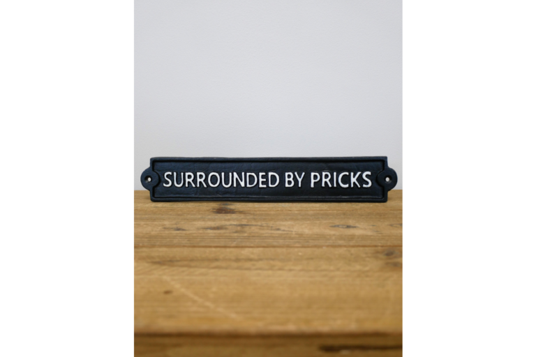 Surrounded By Pricks Cast Iron Sign