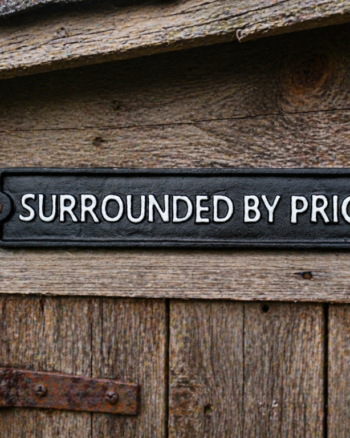 Surrounded By Pricks Cast Iron Sign