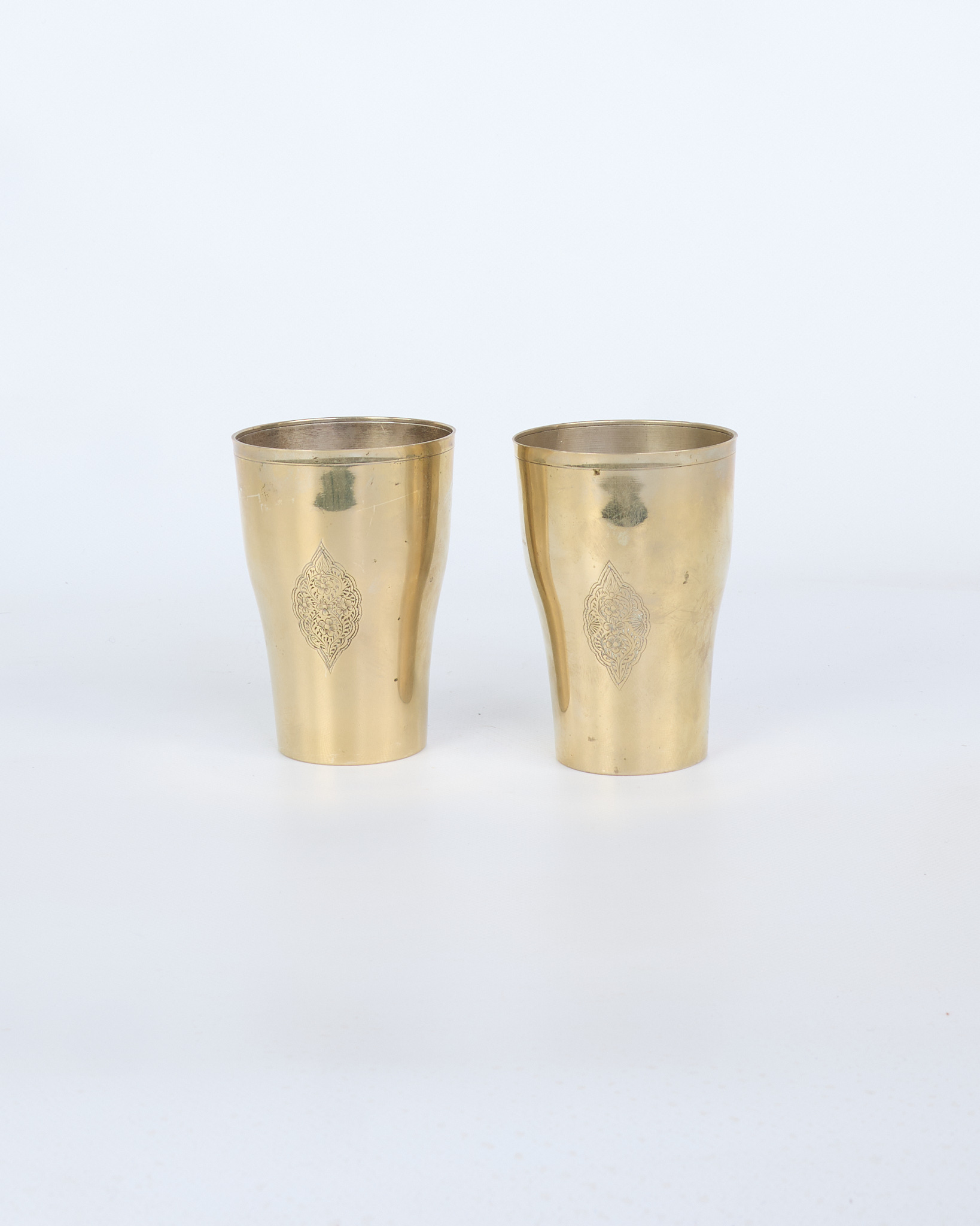 Vintage Brass Tumblers with Intricate Oriental Engraved Motif