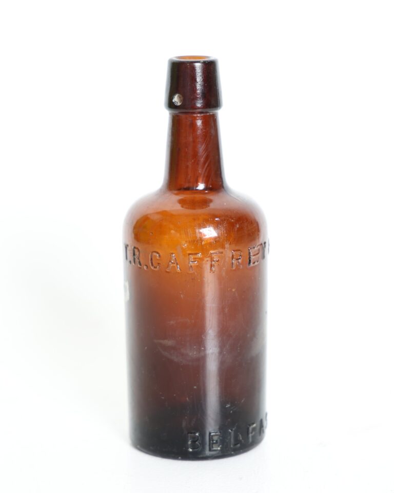 T R Caffrey and Sons Belfast Embossed Brown Glass Bottle