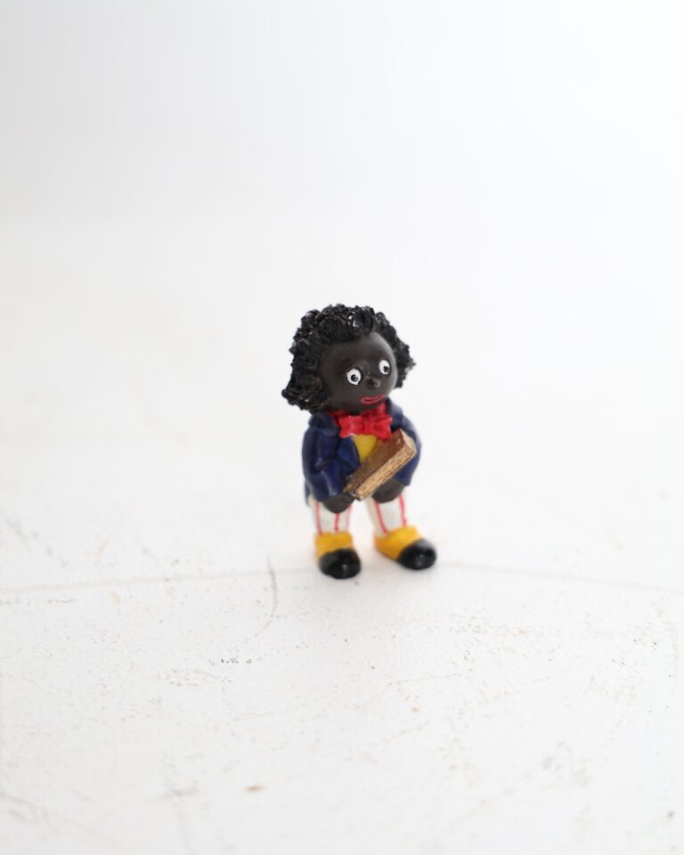 Small Golly Figurine Holding a Golden Book