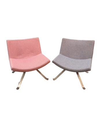 Pair of grey and pink upholstered swivel lounge chairs on a white background